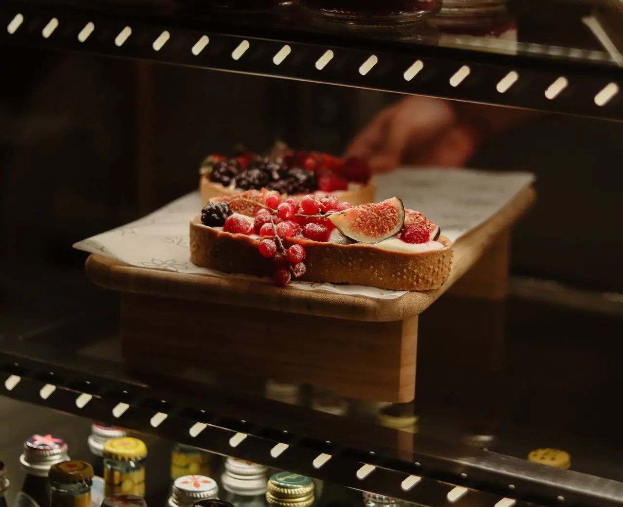 Artisan baked loaf and tarts topped with fresh ripe figs, raspberries, and redcurrants