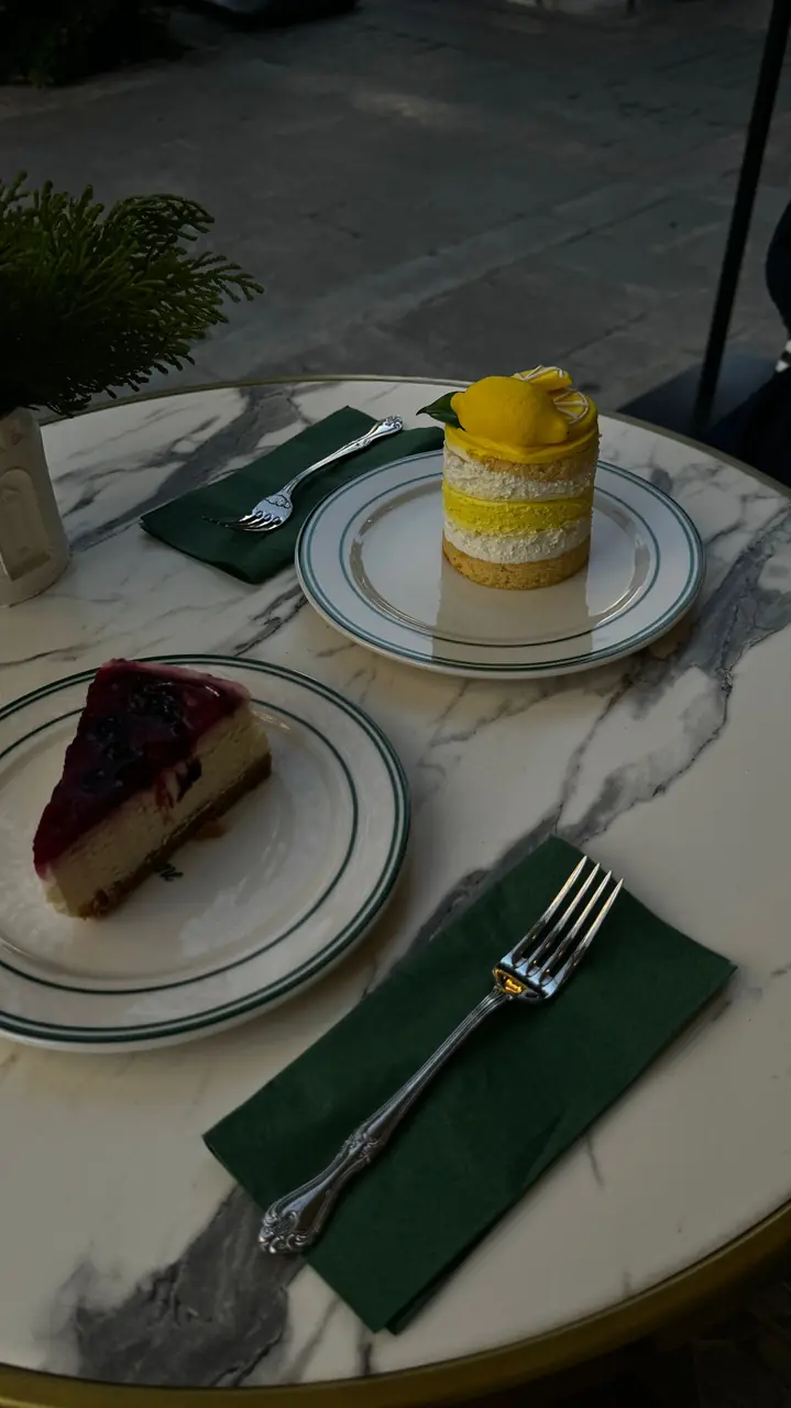Delicate lemon and fresh seasonal berry desserts on an elegant marble table