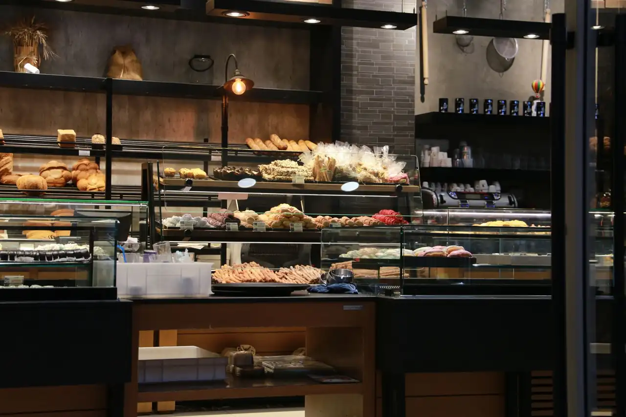 Warm, serene café interior featuring natural timber, soft linen seating, and ambient lighting