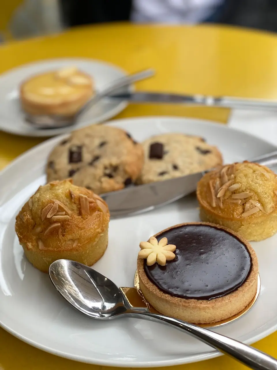 Artisanal French pastries including chocolate and almond delicacies on fine ceramic tableware